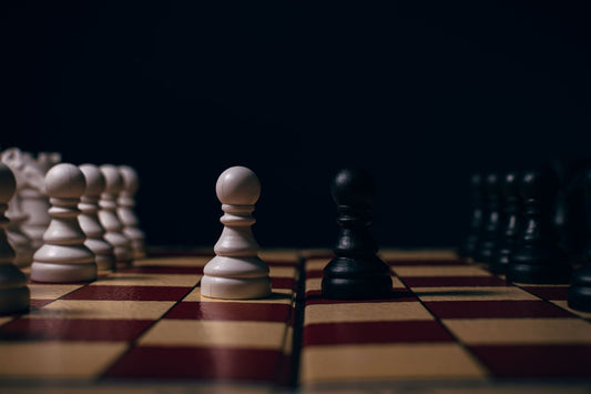 échiquier dans un endroit sombre avec des pièces blanches et des pièces noires
